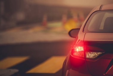 Vehicle Left Turn Signal on a Road Intersection Close Up. Safety Driving Theme.