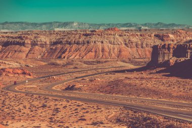 State of Utah Interstate 70 Highway Scenery, Rocky Deserted Formations. Semi Tractor Truck on a Road.