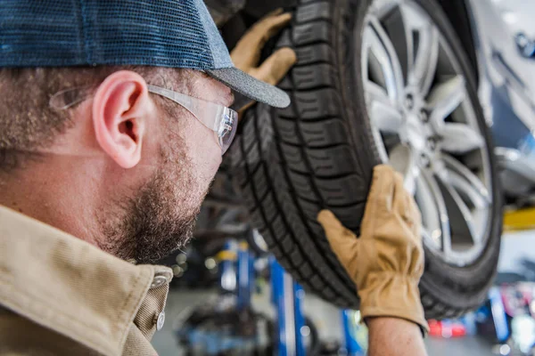 Caucasian Professional Authorized Dealership Auto Service Worker Replacing Tires Balancing — стокове фото