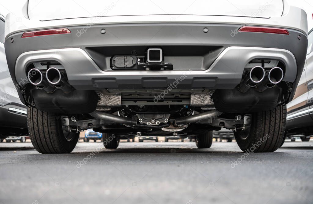 Rear Side of a Vehicle. Exhaust System in Brand New Modern Car. Automotive Industry Theme.
