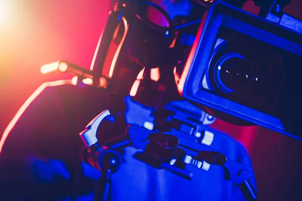 Caucasian Camera Operator Modern Digital Cinema Equipment Dark Blue Studio — Stock Photo, Image