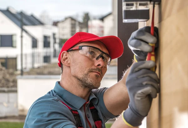 Caucasian Professional Electrician Installing Outdoor Wall Mounted Patio Led Lighting — Stok fotoğraf