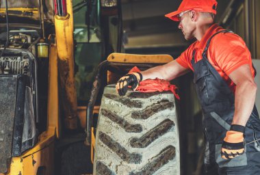 Heavy Duty Equipment Machinery Repaired by Caucasian Professional Mechanic