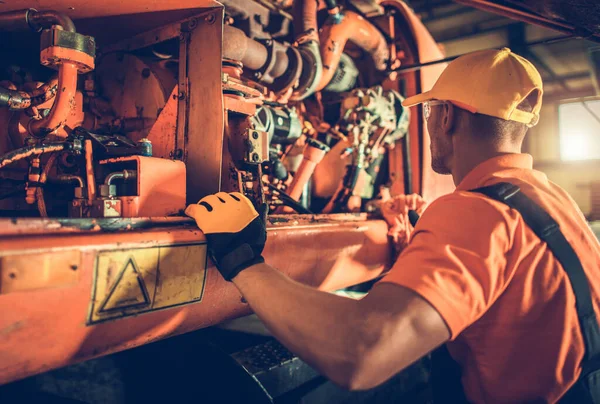 Caucasian Heavy Construction Equipment Mechanic His 40S Repairing Bulldozer Engine — стокове фото