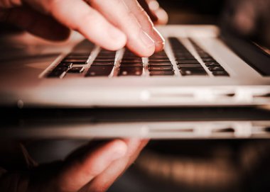 Office Worker Using Laptop Computer on a Glassy Desk. Remote Working Concept.