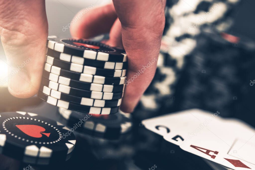 Poker Game Betting Round. Close Up of a Player Placing Another Bid with Eight Casino Chips.