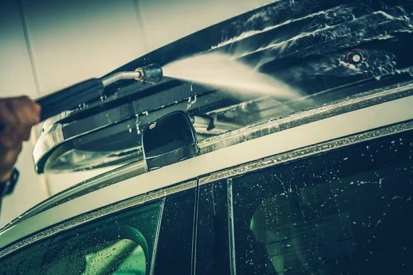 Cleaning the Roof Rack Using Pressure Washer at a Local Car Wash.