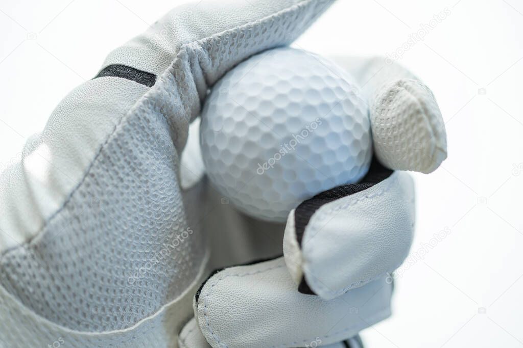 Golf Ball in Hand of a Player. Sportsman Wearing Golf Glove on His Hand. Close Up.