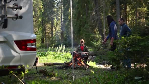 Three Caucasian Friends Hanging Out Campfire Next Motorhome Recreational Vehicle — Stockvideo