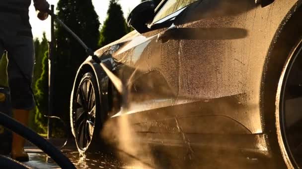 男人在日落时用强力压力清洗机清洗他的现代豪华轿车 汽车维修主题 — 图库视频影像