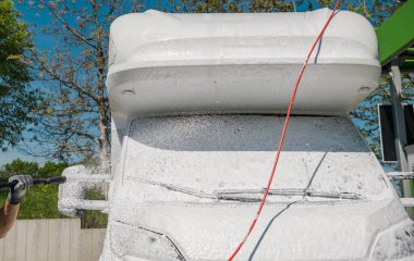 Modern Camper Van RV Body Cleaning by Active Foam. Motorhome Maintenance Theme.