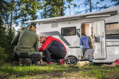 Friends Hanging Next to Their Class C RV Camper Van. Recreational Vehicles and Camping Theme.