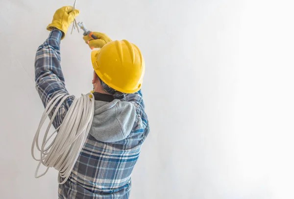 Professional Electrician Wearing Yellow Hard Hat Doing Illumination Installation Preparation — стоковое фото