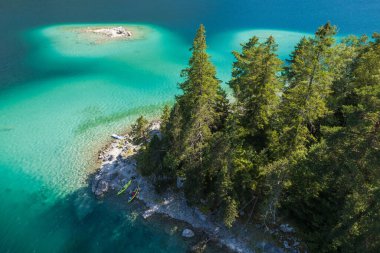 Touring Kayaks on a Scenic Rocky Lake Shore Aerial View. Kayaking Water Sports. Outdoors Pursuit Theme.