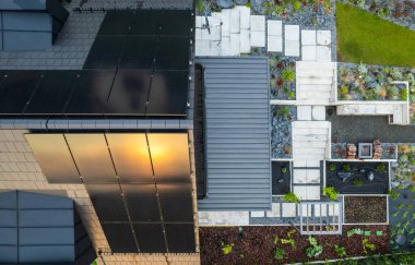 Modern House with Solar Panels and Beautiful Backyard Garden Aerial View.