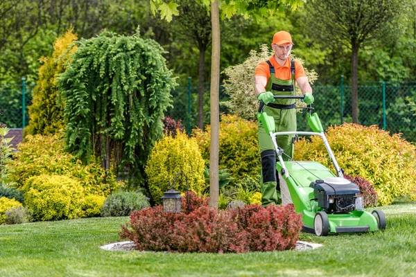 Caucasian Greenskeeper Trimming Grass His Clients Backyard Garden Electric Lawn — Fotografia de Stock