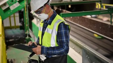 Waste Sorting Facility Management Control. Trash Conveyors Operator Performing Daily Check.
