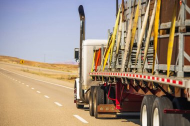 American Semi Truck Trailer Oversize Cargo Secured with Lashing Straps. Heavy Duty Transportation Safety Theme. 
