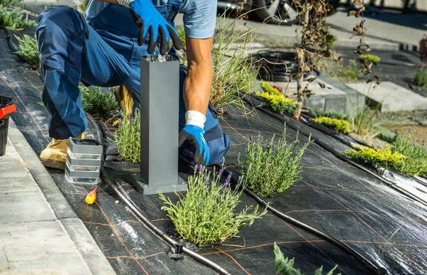 Caucasian Landscaping Worker Installing Replacing Regular Bulb Small Garden Light — Fotografia de Stock