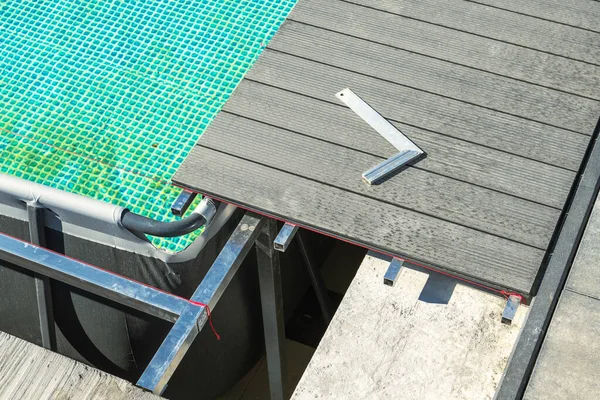 Outdoor Expansion Swimming Pool Composite Deck Building Close Up. Aluminium Framing. Industrial Theme.