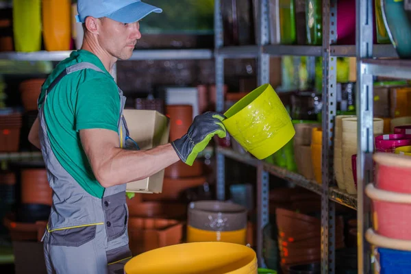 Caucasian Middle Aged Gardening Shop Worker Arranging New Supply Plant — Stockfoto