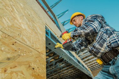 Caucasian Construction Contractor in His 40s Building House Metal Framing.