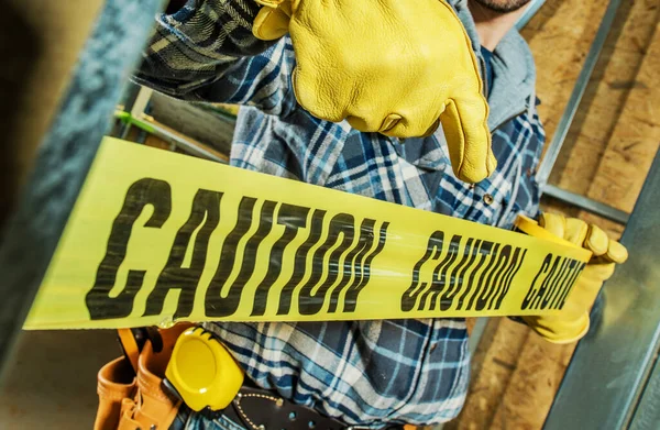 Closeup Construction Worker Wrapping Building Site Yellow Caution Barricade Tape — Stock Photo, Image