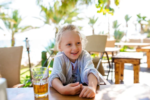 Cute Little Girl Drinking Sea Buckthorn Fruit Drink Cafe Stock Image