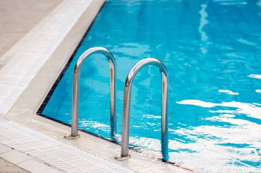 Yüzme havuzuna inmek için merdiven paslanmaz tırabzanlar.