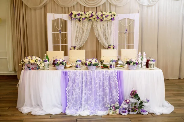 decoration of the festive dinner with rose flowers on the wedding table in the interior of the restaurant. Decorated table for celebration