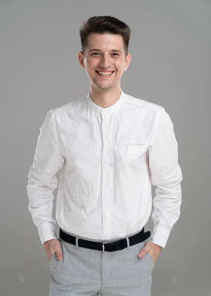 Handsome Confident Young Man Standing Smiling White Shirt Grey Background — Stockfoto