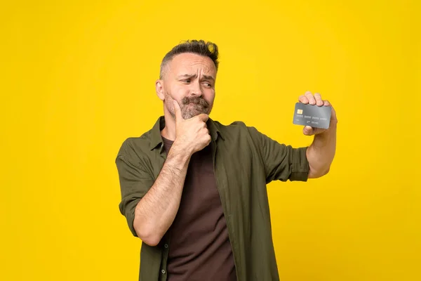 Middle Age Doubtful Man Holding Credit Card Thinking What Buy — Stock Photo, Image