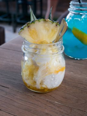 Pineapple smoothie with fresh pineapple  and Blue curacao cocktail on wooden background