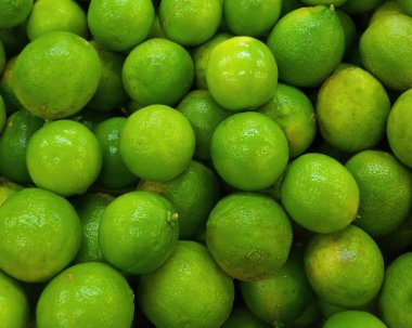Colorful display of lemons In market. Macro photo of a ripe juicy lemon fruit.