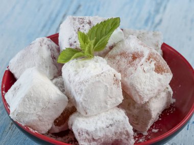 Turkish delights in plate on vintage table. Sweet Turkish delight lokum traditional dessert.