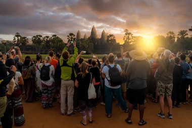 People take a photo in Angkor Wat temple at sunrise in Angkor Thom, Siem Reap, Cambodia