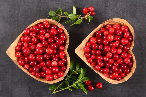 Cowberries Wooden Heart Shaped Bowls Black Background Top View — Stock Photo, Image