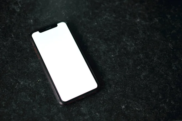 Mockup image of a mobile phone with a blank white screen. — Photo