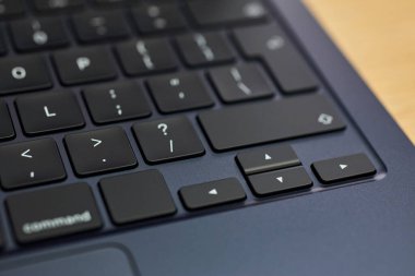 Modern, slim, backlit laptop membrane keyboard. Black keyboard large board. Selective focus. close-up of laptop keys.