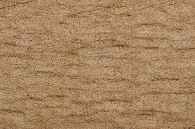 Yellow sandy natural stone of yellow color. Rough natural stone.