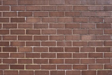 The texture of a neat brown stone. Smooth brickwork with brown smooth stone. The texture of the wall of the English house.