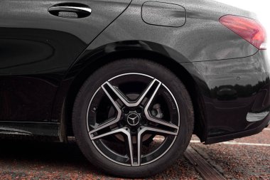 UK, Newcastle, 27 August 2022: New diesel Mercedes sedan A class a180d 2022. Black executive sedan from Mercedes in the AMG package. Close-up of AMG wheels
