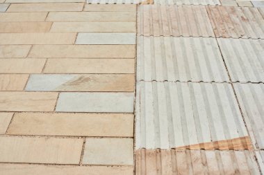 Tactile tiles for the blind. Panels for the blind laid on asphalt. Guide tape for the disabled. Red new tactile tiles for the visually impaired. Equipped modern pedestrian crossing with new asphalt.