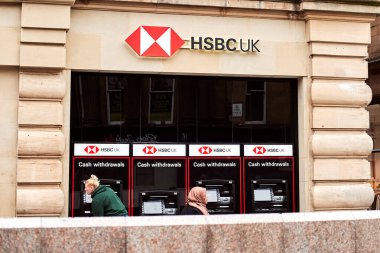 Newcastle, England, 20 August 2022: HSBC UK bank. The facade of the old bank is in an old building. ATMs stand in line behind the glazing