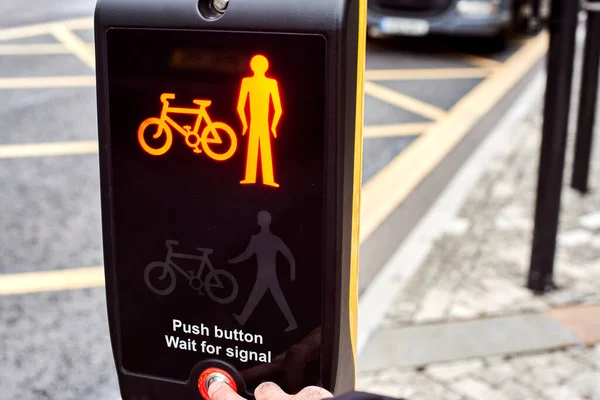 The concept of a safe city. Traffic rules for children. Convenient traffic light with button. Traffic lights in England.