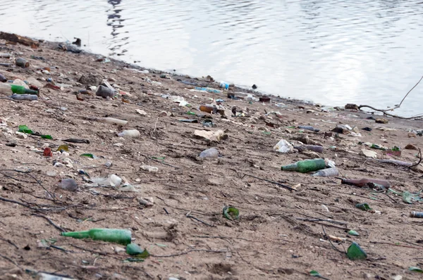 Stack of different types garbage on the river bank — Stock Photo, Image