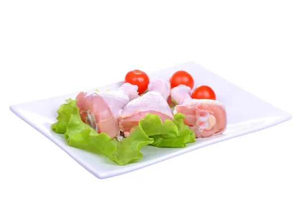 Fresh raw chicken legs on the plate. Isolated on a white — Stock Photo, Image