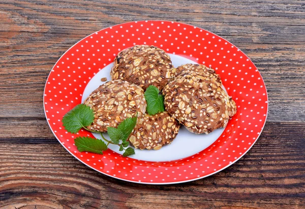 Biscuits aux céréales bio sur une assiette sur fond de bois — Photo