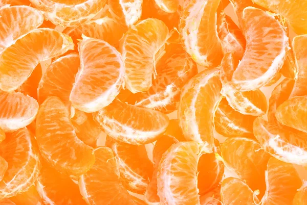 Gepelde mandarijn of mandarin fruit als achtergrond — Stockfoto