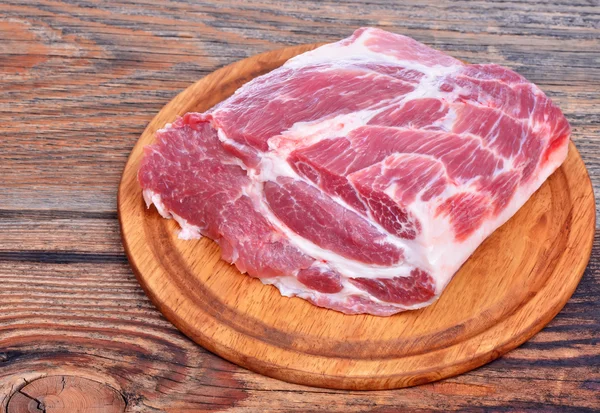 Raw pork meat on wooden board — Stock Photo, Image